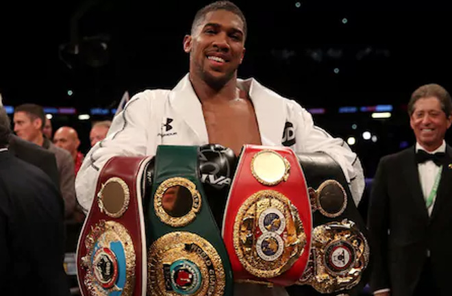 Anthony Joshua celebrates with his belts after victory over Joseph Parker. Photo Credit: The Telegraph