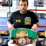 Joe Gallagher with titles won by his fighters. Photo credit: manchestereveningnews.co.uk