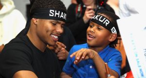 Shakur Stevenson signing autographs for a young fan who also received an official Team Stevenson headband. Photo Credit: Mikey Williams/Top Rank