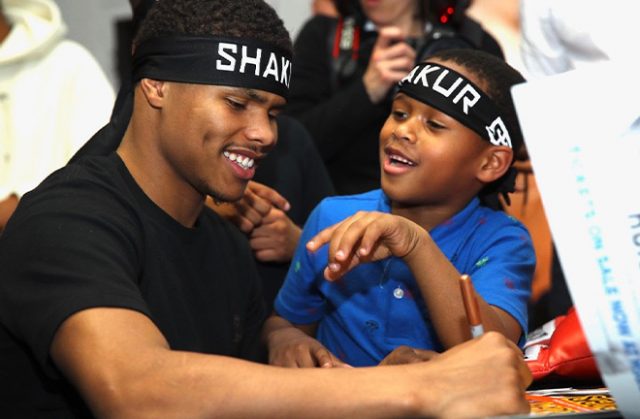 Shakur Stevenson signing autographs for a young fan who also received an official Team Stevenson headband. Photo Credit: Mikey Williams/Top Rank