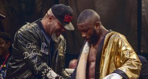 Derrick Osaze receiving the Ultimate Boxxer golden robe from Shannon Briggs. Photo Credit: London News Online