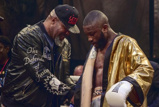 Derrick Osaze receiving the Ultimate Boxxer golden robe from Shannon Briggs. Photo Credit: London News Online