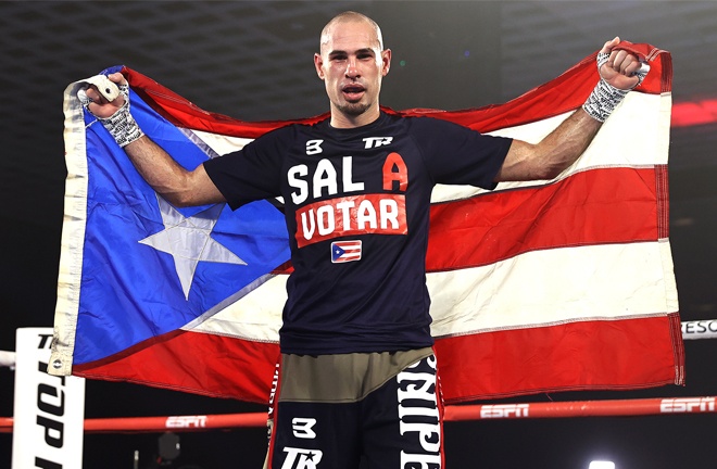 Pedraza holds his Puerto Rican flag aloft after victory Photo Credit: Mikey Williams / Top Rank