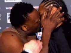 Derek Chisora landing a kiss on his opponent Carl Baker. Photo Credit: boxingnews24
