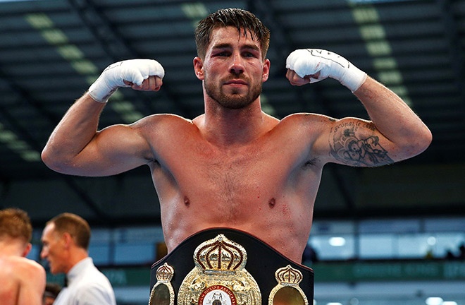 Jamie Cox with one of his titles he claimed iduring his winning streak. Photo Credit: Boxing News Online