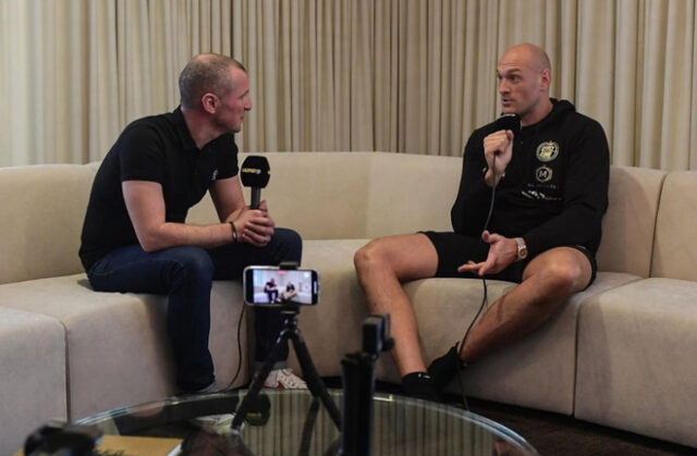 Catterall interviewing Tyson Fury on fight week ahead of his victory over Deontay Wilder in Las Vegas last February Photo Credit: Instagram: @adamcatterall