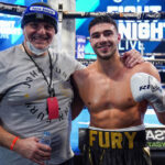 Tommy Fury celebrates with father, John Fury after picking up his fifth professional win in emphatic fashion Photo Credit: Round ‘N’ Bout Media/Queensberry Promotions