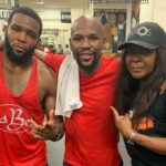Denis Douglin alongside Floyd Mayweather Jr and his mum and trainer after a 2am sparring session last year Photo Credit: Instagram @mommasboy_denis