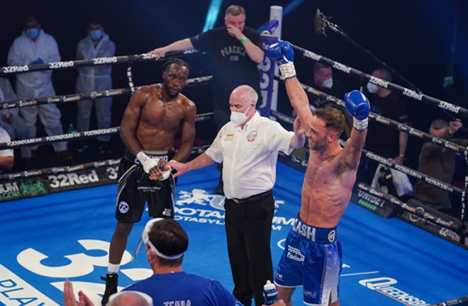 Cash celebrates after adding another belt to his collection Photo Credit: Round 'N' Bout Media/Queensberry Promotions