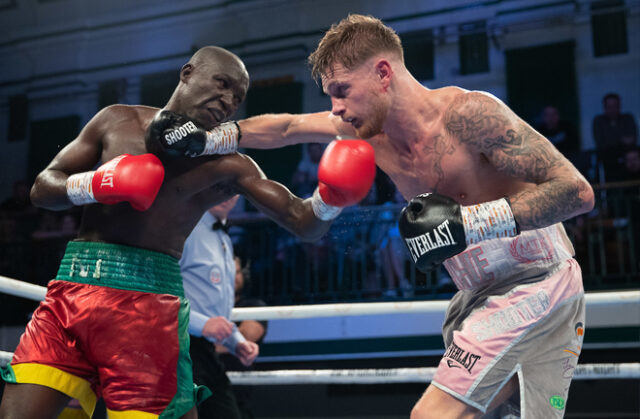 Archie Sharp defended his WBO Global super featherweight title for the first time with a 100-90 points win on all 3 judges scorecards against Alexis Boureima Kabore. Photo Credit: MTK Global.