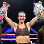 Mayer holds the IBF and WBO belts Photo Credit: Mikey Williams / Top Rank via Getty Images