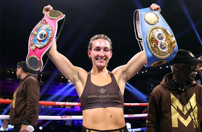 Mayer holds the IBF and WBO belts Photo Credit: Mikey Williams / Top Rank via Getty Images