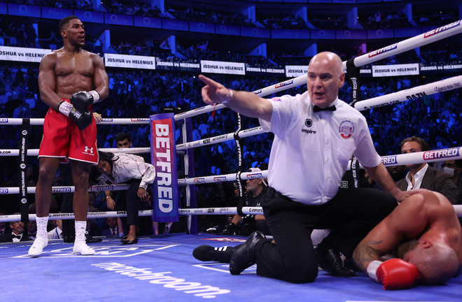 Referee Victor Loughlin waved and waved after Joshua landed a devastating right hand on Helenius.  Photo: Mark Robinson/Matchroom Boxing